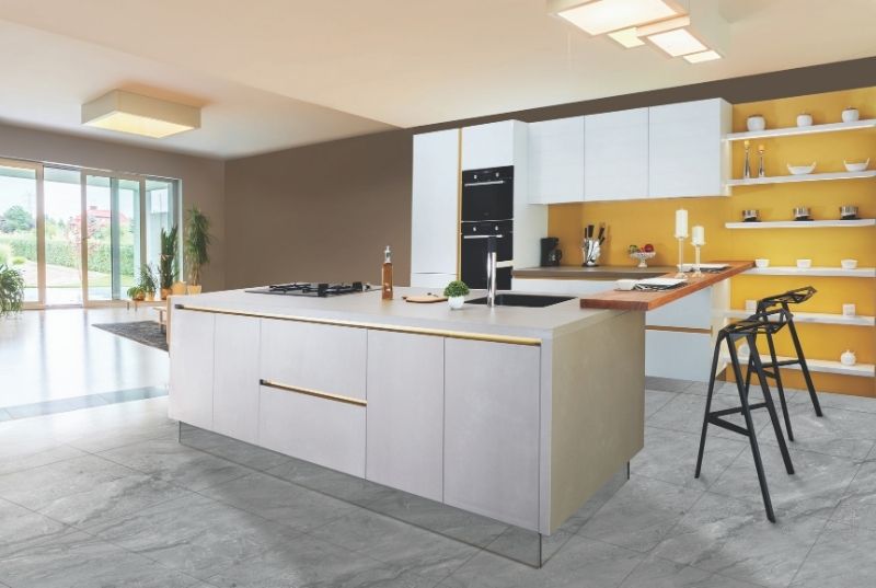 Kitchen with grey tiled flooring and a central island housing the sink