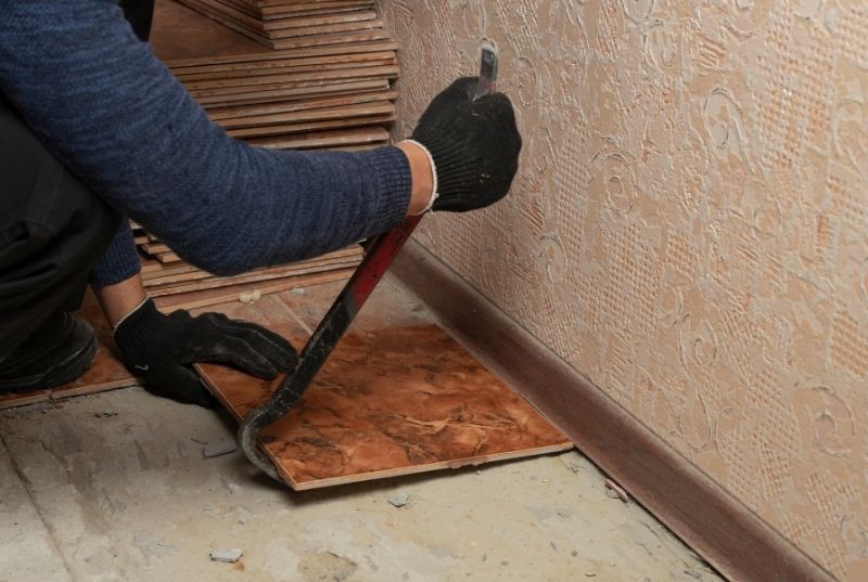 Person doing floor tiles removal