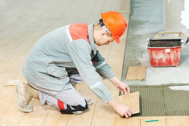 Tiler laying outdoor tiles for a commercial installation in Wollongong