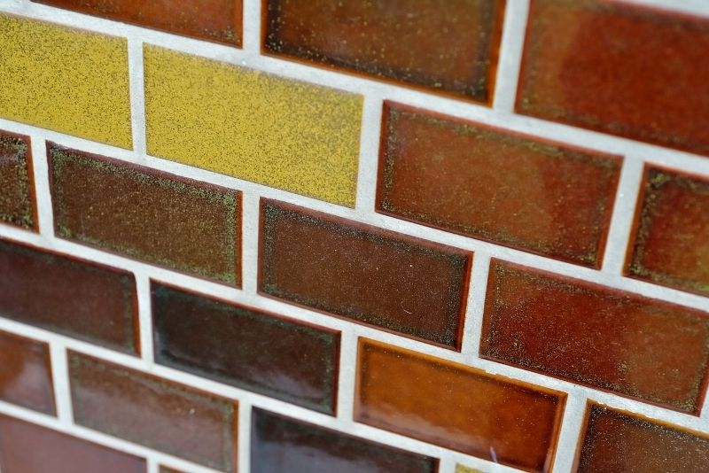 Wall mosaic tiles in terracotta colours with white grout