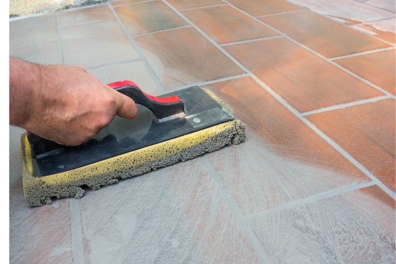 Tiler installing outdoor floor tiles